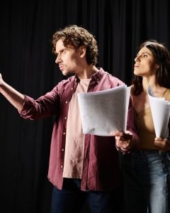Rehearsing Partners: Man and Woman With Papers