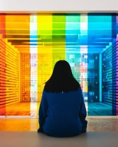 Woman sitting in colorful gallery